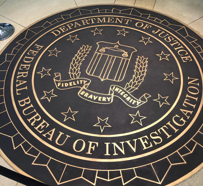 Image of the FBI seal embedded the floor in dark brown and gold.